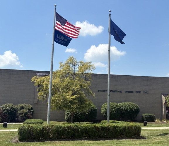 A photo of the WAI flag flying with the United States of America flag.